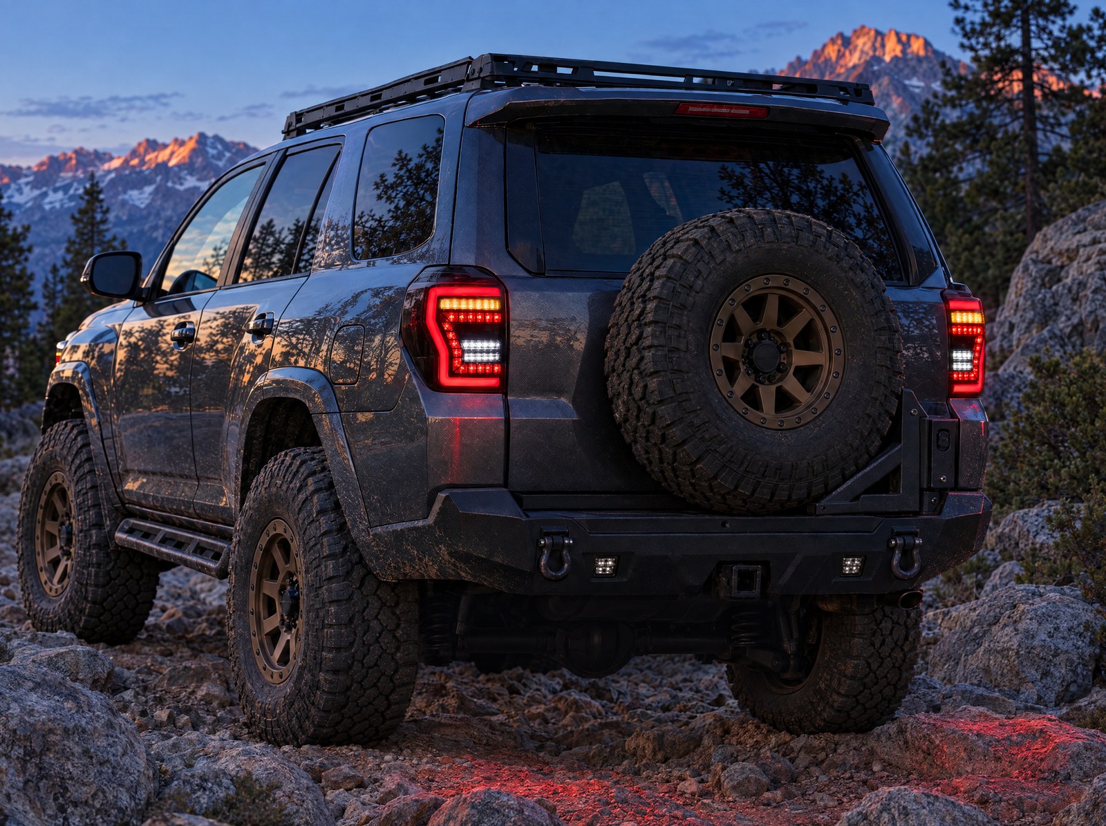 LED tail lights installed on a lifted, off-road built 2014–2024 Toyota 4Runner on a rocky mountain trail at dusk